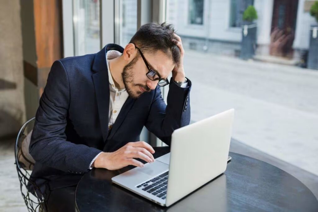 A person stuck in dispatch chaos, ignoring trucking dispatch software